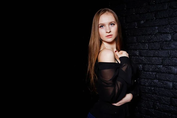 Studio shot of brunette girl in black blouse with bra and shorts — Stock Photo, Image