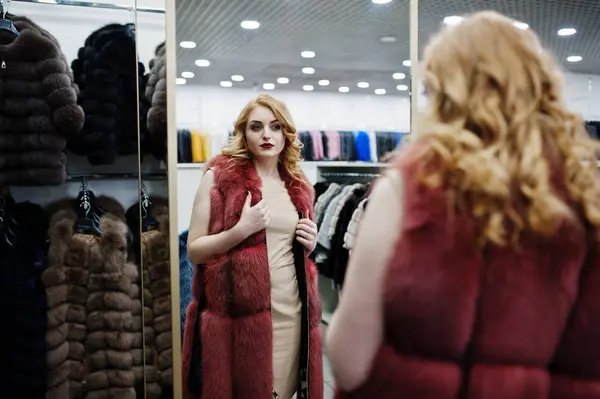 Elegance blonde girl in fur coat at the store of fur coats and l — Stock Photo, Image