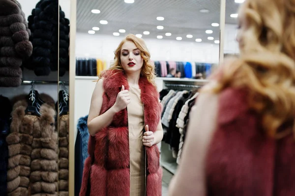 Elegance blonde girl in fur coat at the store of fur coats and l — Stock Photo, Image