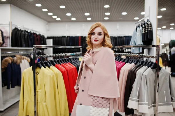 Elegance blonde girl in coat at the store of fur coats and leath — Stock Photo, Image