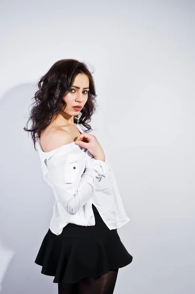 Studio portrait of brunette girl in white blouse on white backgr — Stock Photo, Image