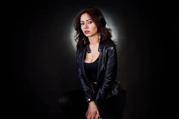 stock image Studio portrait of sexy brunette girl in black leather jacket ag