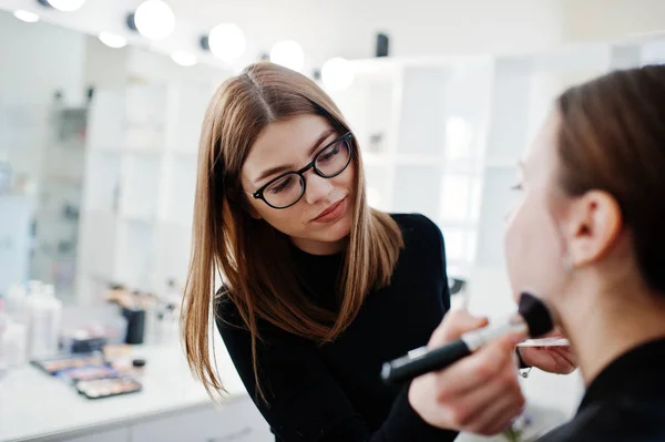 Make up artist work in her beauty visage studio salon. Woman app
