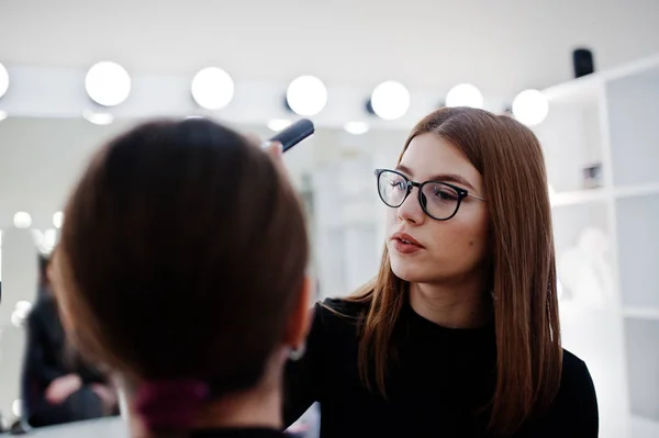 Make up artist work in her beauty visage studio salon. Woman app