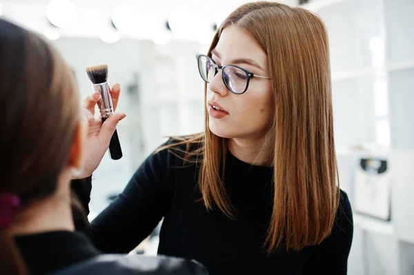 Make up artist work in her beauty visage studio salon. Woman app