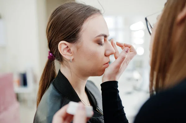 Make up artist work in her beauty visage studio salon. Woman app