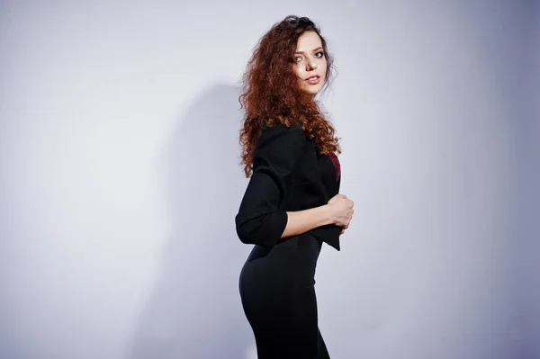 Brunette curly haired girl in black office jacket with skirt, on — Stock Photo, Image