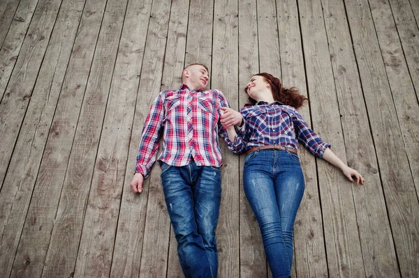 Casal elegante desgaste na camisa xadrez no amor juntos mentira em t — Fotografia de Stock