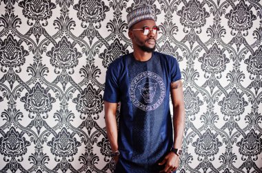 Zengin Afrika adam şık geleneksel giysiler ve şapka cam