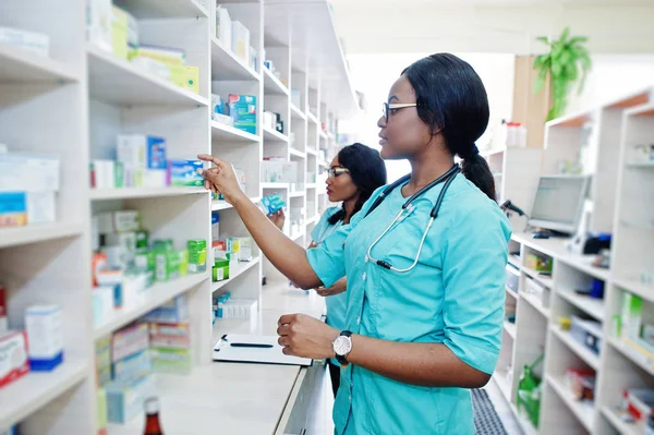 stock image Two african american pharmacist working in drugstore at hospital