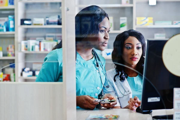 Dos farmacéuticos afroamericanos trabajando en farmacia en el hospital — Foto de Stock