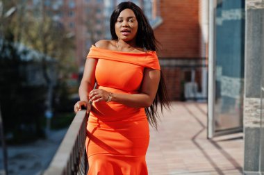 African american woman model xxl in orange dress. clipart