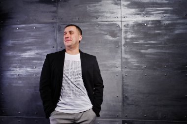 Çelik arka plan karşı rahat kıyafetli adam portresi stüdyo.