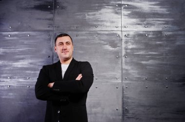 Çelik arka plan karşı rahat kıyafetli adam portresi stüdyo.