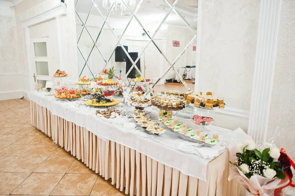Desszert asztal finom édességek esküvői recepción. — Stock Fotó