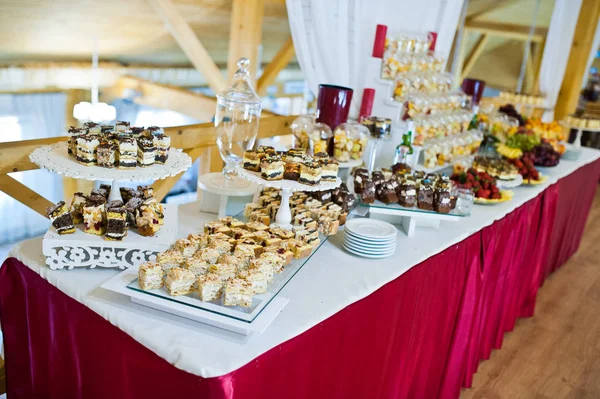 Dessert table of delicious sweets on wedding reception.