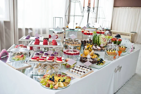 Mesa de sobremesa de doces deliciosos na recepção do casamento. — Fotografia de Stock
