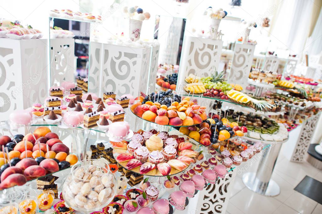 Dessert table of delicious sweets on wedding reception.