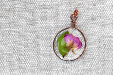 handmade epoxy resin jewelry. pendant, rose in copper frame. clipart