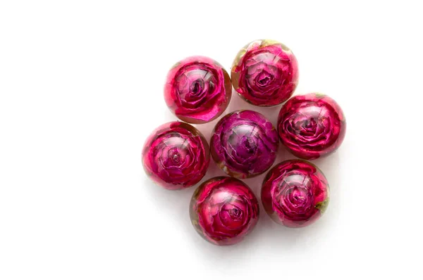 handmade epoxy resin jewelry. roses in sphere, seven pieces. top view. dried flowers. herbarium, oshibana. isolated on white background
