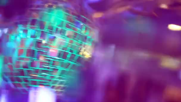 Multicolored light shimmers and reflects off the mirrored disco balls — Stock video