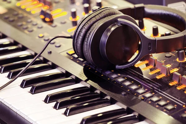 Headphones on musical synthesizer keyboard.