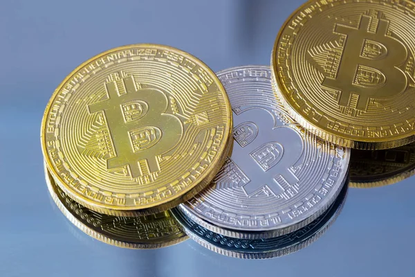 Metal bitcoins on mirror background — Stock Photo, Image