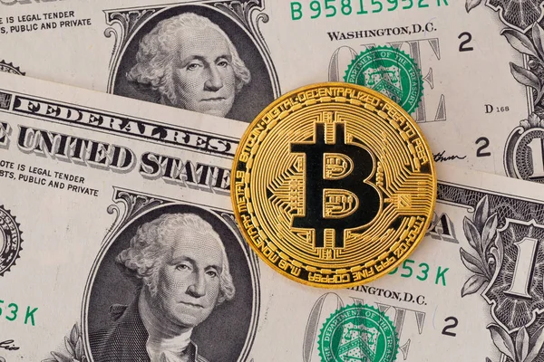 Golden metal bitcoin on one dollar bills background — Stock Photo, Image