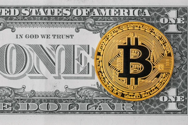 Golden metal bitcoin and one dollar bill Royalty Free Stock Images