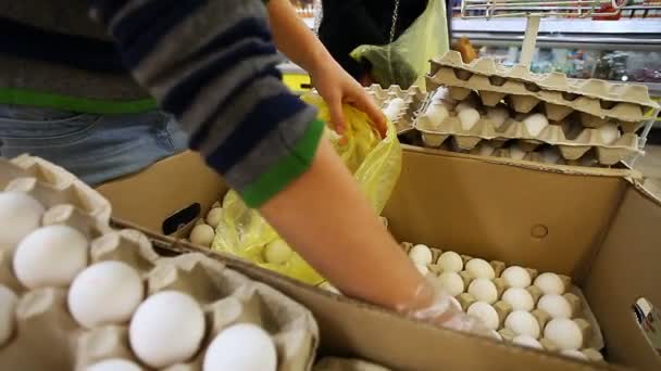 Женщина покупает яйца в супермаркете — стоковое видео
