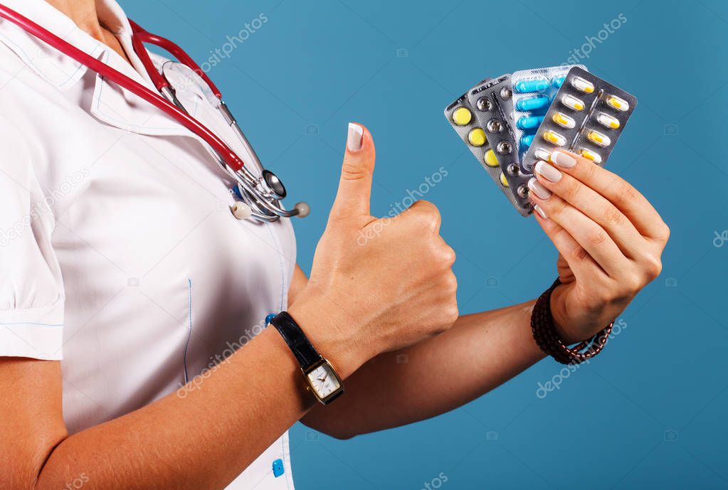 Doctor with pills in hand closeup
