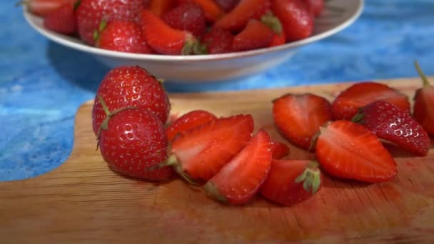 Slow motion footage slices of juicy red strawberries — Stock Video