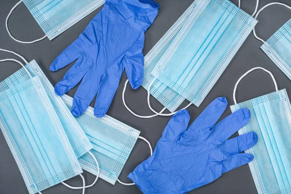 Set of medical blue masks and rubber gloves. Protective equipment during a pandemic. Studio shot.