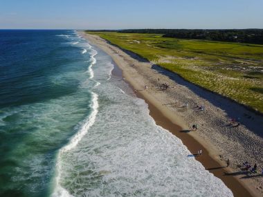 Aerial of Waves Washing Onto Cape Cod Beach clipart