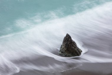 The cold waters of the Pacific Ocean wash against the a beach found along the northern California coastline in Sonoma. This scenic region, north of San Francisco, is accessible via the famous highway one. clipart