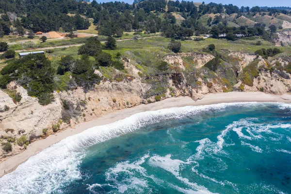 The Pacific Ocean washes against the beautiful and rugged coastline not far from Santa Cruz, California. This area, south of San Francisco, is known for its great surfing and gorgeous beaches.