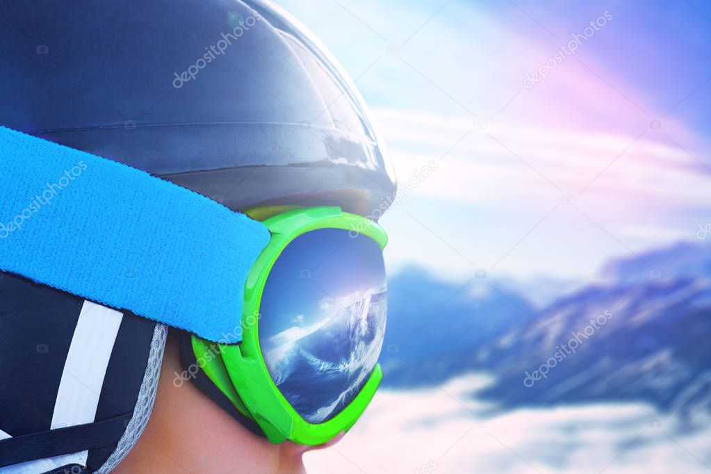 Reflection of the winter mountain landscape in a ski mask