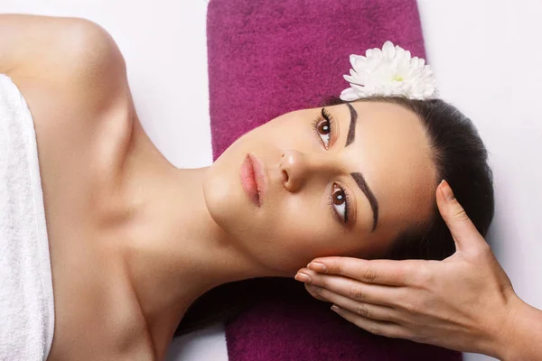 Masajista haciendo masaje la cabeza de la mujer en el salón de spa.Facial — Foto de Stock