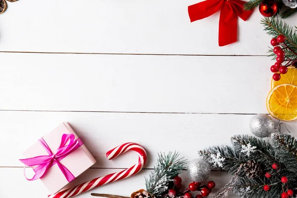 Prachtige Kerstcompositie Houten Witte Achtergrond Kerstdozen Besneeuwde Dennentakken Naaldbomen Karamelstokje — Stockfoto