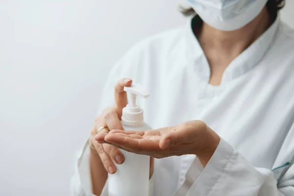 stock image Woman hand using alcohol wash gel for cleaning sanitize gel pump dispenser on white background, health care concept