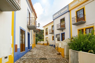 Village street with residential buildings in the town of Bordeira near Carrapateira, in the municipality of Aljezur in the District of Faro, Algarve Portugal clipart