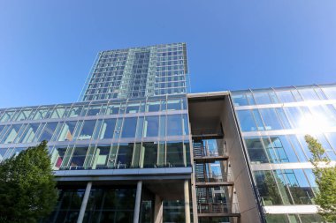 Şehir merkezinde yeni bir iş alanında modern bir ticari ve konut binasının cephesine sahip.