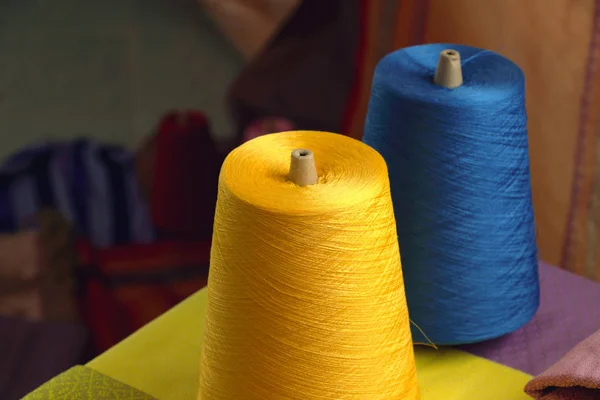 Spools of yellow and blue silk thread for woven in silk in Thail — Stock Photo, Image