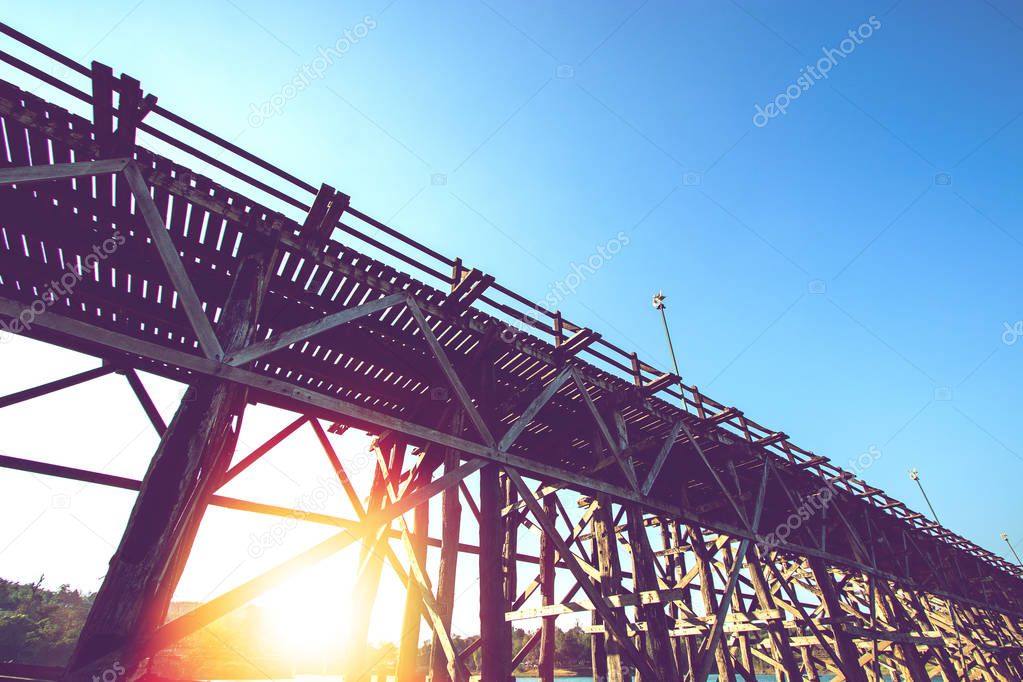 under wooden bridge over river in the morning