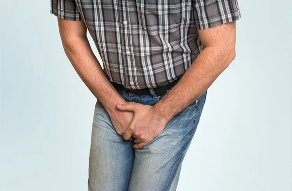 Man with hands holding his crotch, he wants to pee — Stock Image Man with hands holding his crotch, he wants to pee Royalty Free Stock Photos