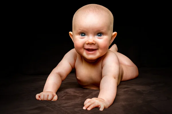 Happy and funny newborn baby on black — Stock Photo, Image