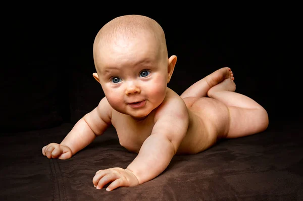 Happy and funny newborn baby on black — Stock Photo, Image