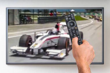 Man is watching formula one racing on TV clipart