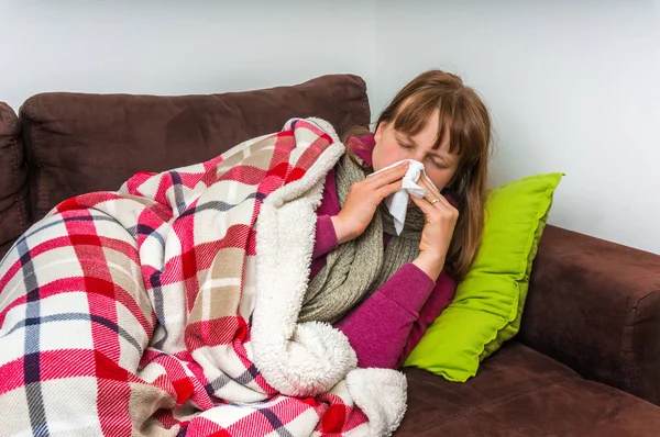 Sick woman having flu and blowing her runny nose — Stock Photo, Image
