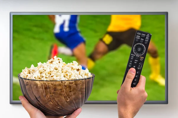 Man is watching football match on TV — Stock Photo, Image